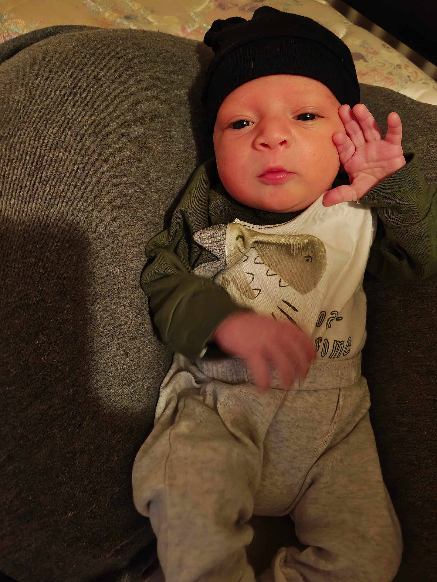 Ryatt joined the competition — help win amazing prizes! baby, newborn, infant, hat, onesie, pajamas, blanket, cushion, bed, hand, face, eyes_open, mouth, portrait, indoor, cozy, skin, cheek, expression, lying_down