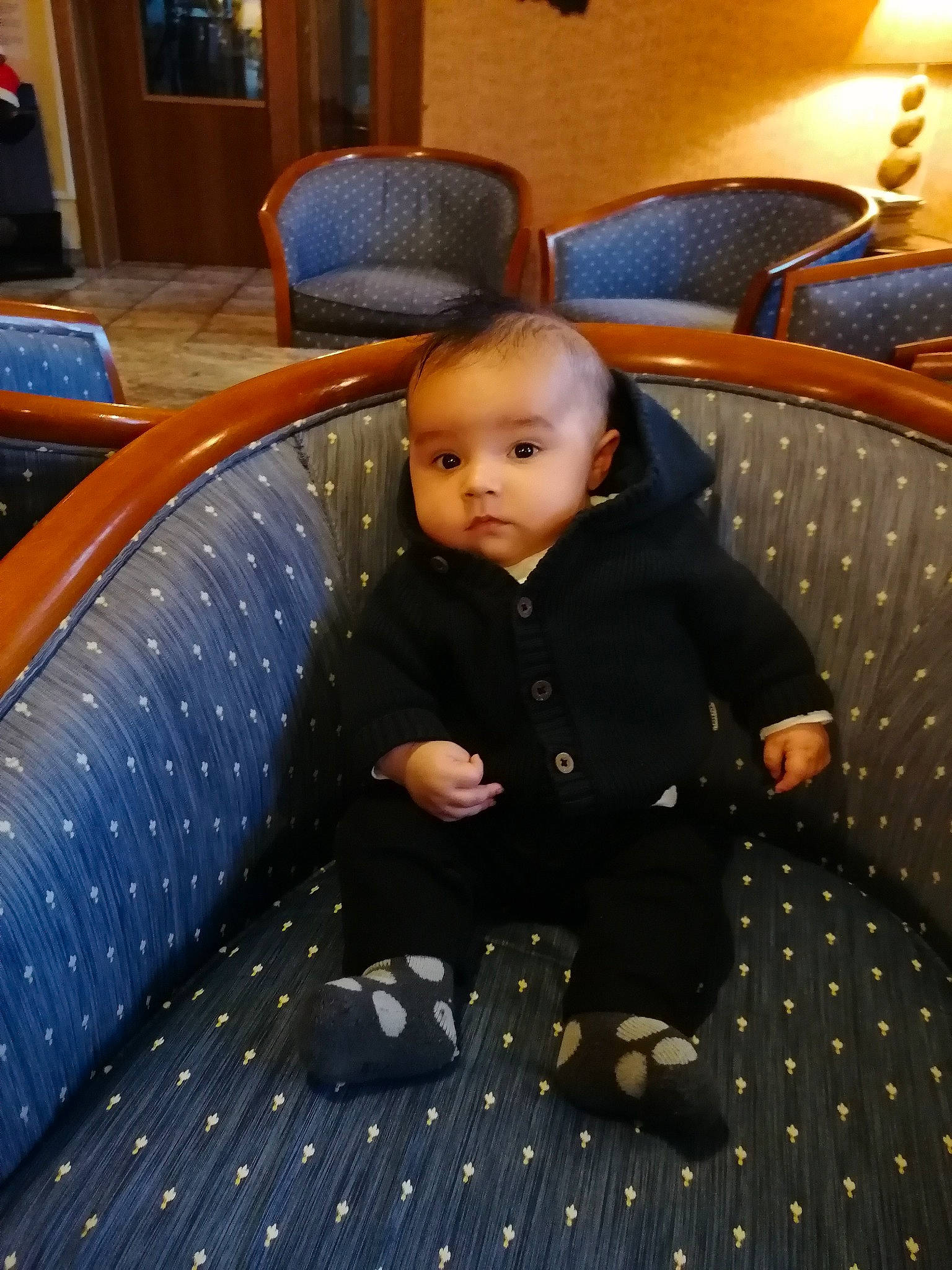 Eyden participe au concours pour gagner de l'argent avec cette photo : baby, baby_toddler_clothing, chair, child, comfort, floor, flooring, fun, furniture, hardwood, leisure, linens, pattern, person, room, sitting, suit, toddler, wood