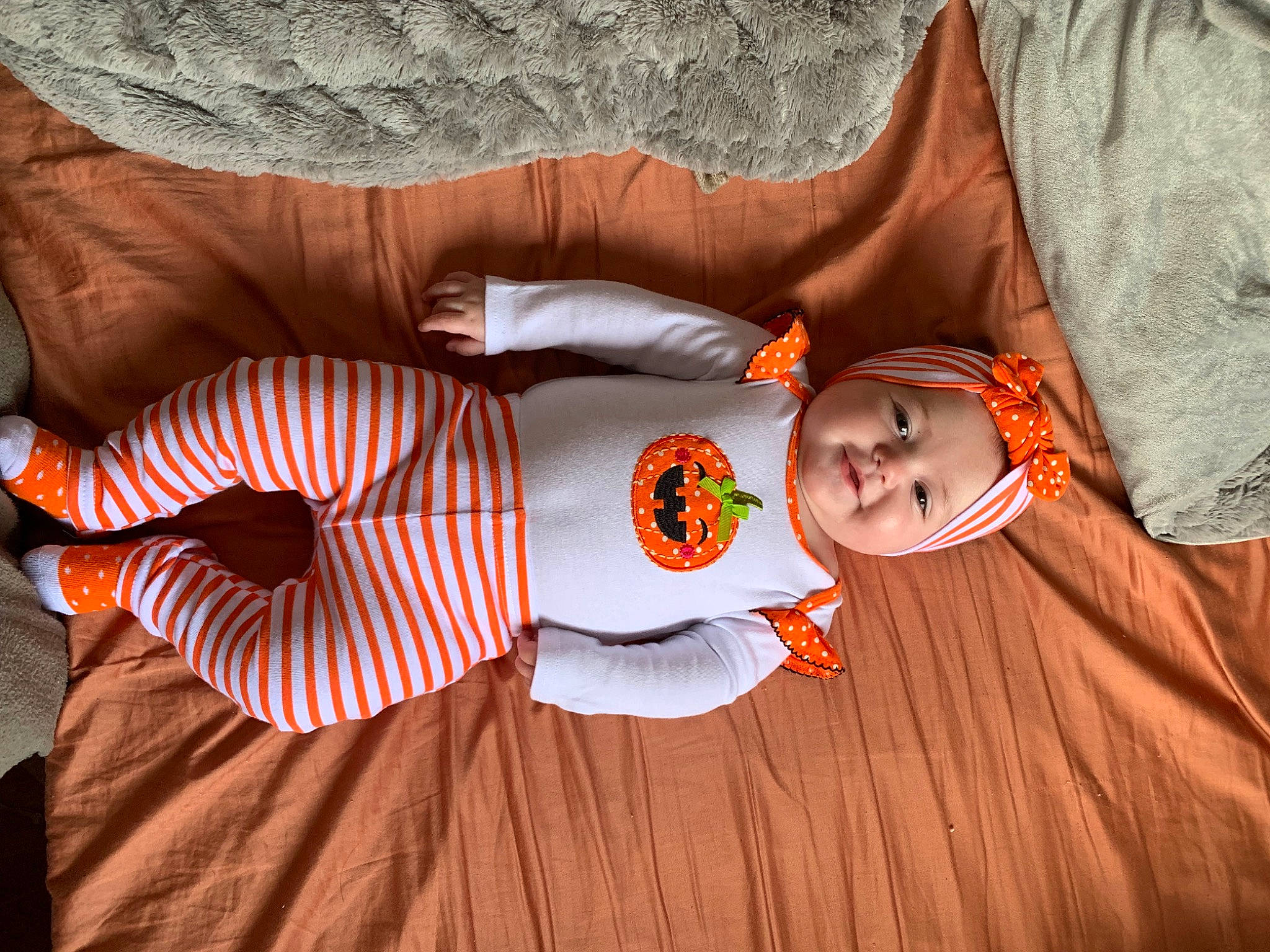 Mariana is registered to the contest to win money with this photo: carmine, child, comfort, fun, happy, hardwood, headwear, human_leg, joy, linens, orange, pattern, peach, person, plaid, room, sleeve, sunglasses, t_shirt, textile