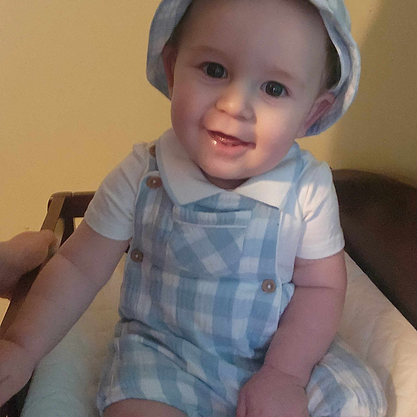 Lennon is registered to the contest to win money with this photo: baby, baseballcap, bonnet, cap, clothing, costume, couch, diaper, face, furniture, happy, hat, head, pants, person, photography, portrait, sitting, smile, sunhat