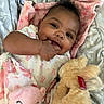baby, infant, smiling, hand, fingers, plush_toy, pink_bear, beige_bunny, blanket, bed, sleepwear, cute, child, lying_down, soft_toys, comfort, happy, indoors, portrait, cozy