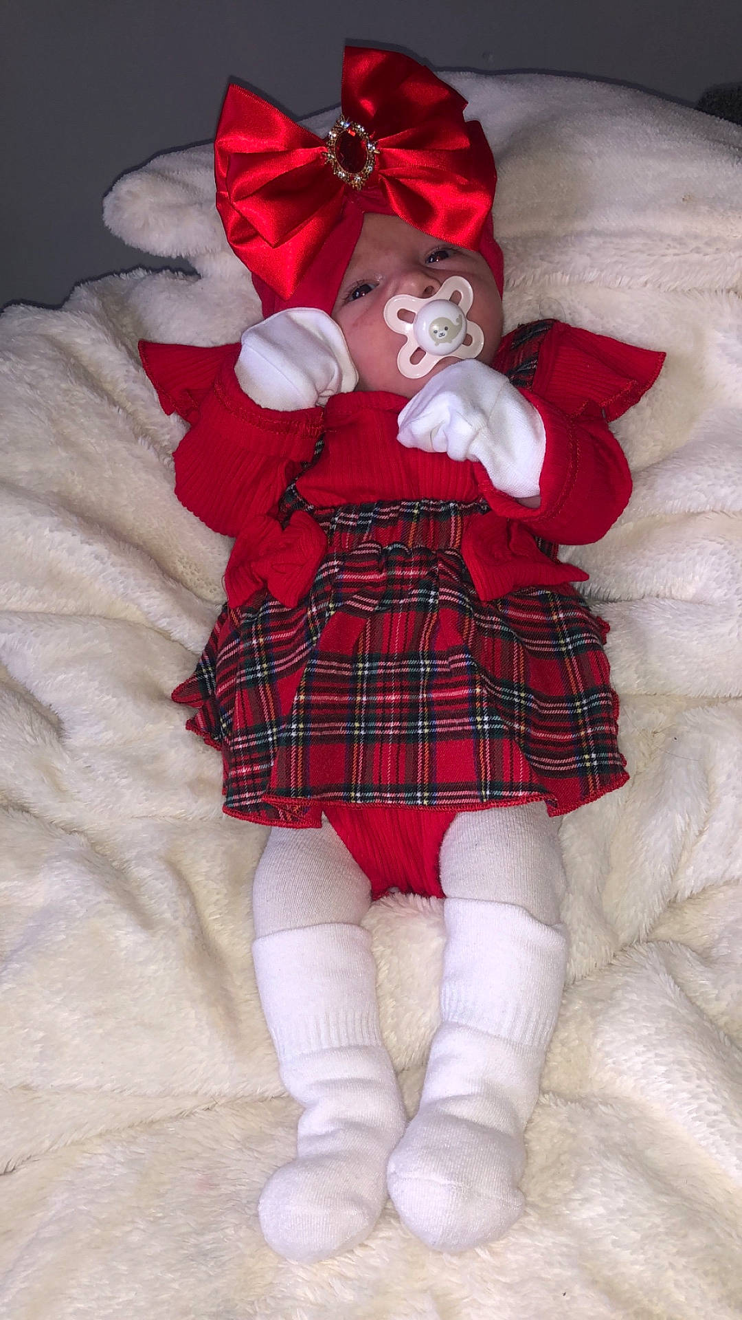 Mya is registered to the contest to win money with this photo: baby, bodypart, bonnet, clothing, costume, face, finger, hand, hat, head, hosiery, kilt, newborn, person, photography, portrait, skirt, sock, tartan, toy