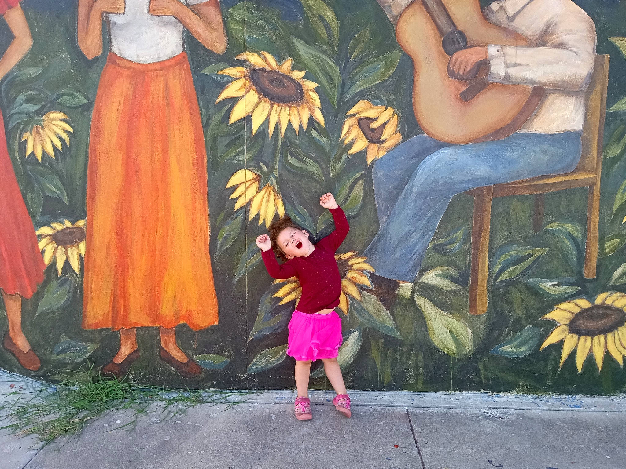 Raelyn is registered to the contest to win money with this photo: art, entertainment, event, fictional_character, fun, happy, human_body, illustration, leisure, mural, organism, painting, people_in_nature, person, plant, sandal, summer, textile, toddler, tree