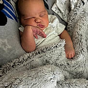 Binyamyin is registered to the contest to win money with this photo: baby, sleeping, blanket, mickey_mouse, pillow, infant, cozy, soft, cute, child, resting, indoor, person, newborn, hand, face, peaceful, fabric, bed, comfort