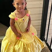 Shiza is registered to the contest to win money with this photo: child, girl, yellow_dress, princess_costume, curly_hair, porch, smiling, standing, outdoor, young, cute, fashion, happy, person, portrait, costume, flower, railing, home, dress