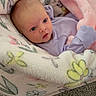baby, infant, blanket, pink_fleece, baby_rocker, carpet, blue_eyes, face, clothing, cute, newborn, soft_texture, floral_pattern, indoors, resting, baby_bedding, small_hands, head, comfort, child