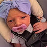 Layla joined the competition — help win amazing prizes! baby, infant, pacifier, car_seat, headband, purple_bow, child, seatbelt, strapped_in, newborn, cute, small_hand, clothing, indoors, portrait, close_up, face, expression, pink, soft