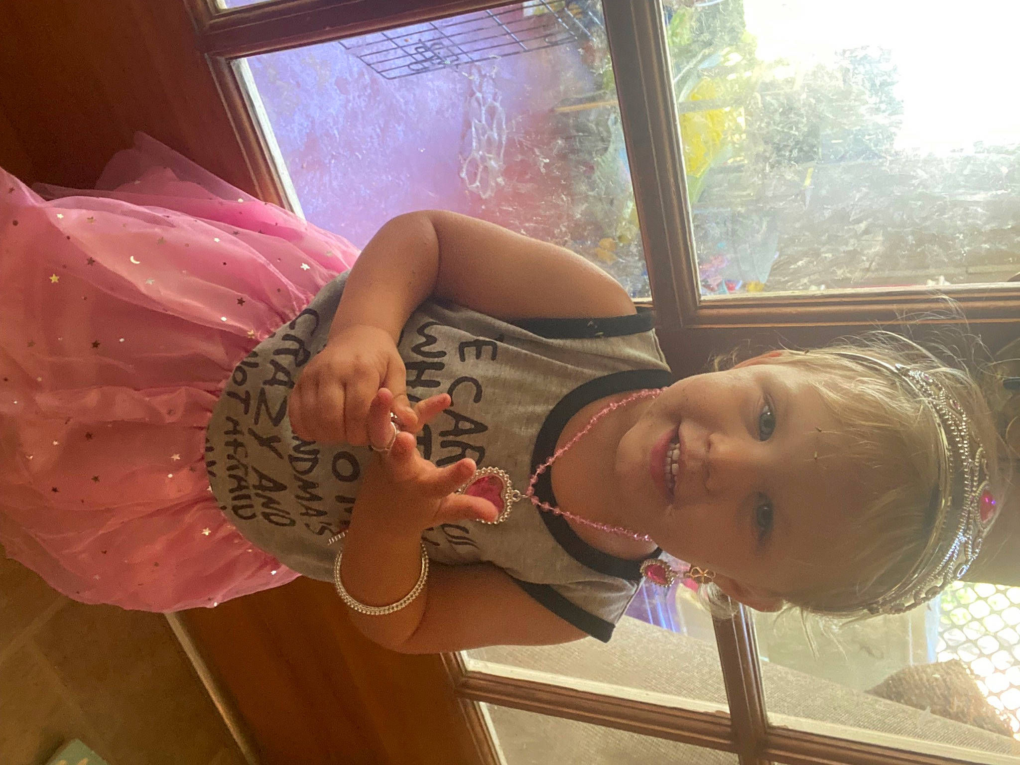 Penny is registered to the contest to win money with this photo: child, eyewear, fun, glass, happy, human_leg, joy, leisure, person, smile, thigh, toddler, tree, window, wood