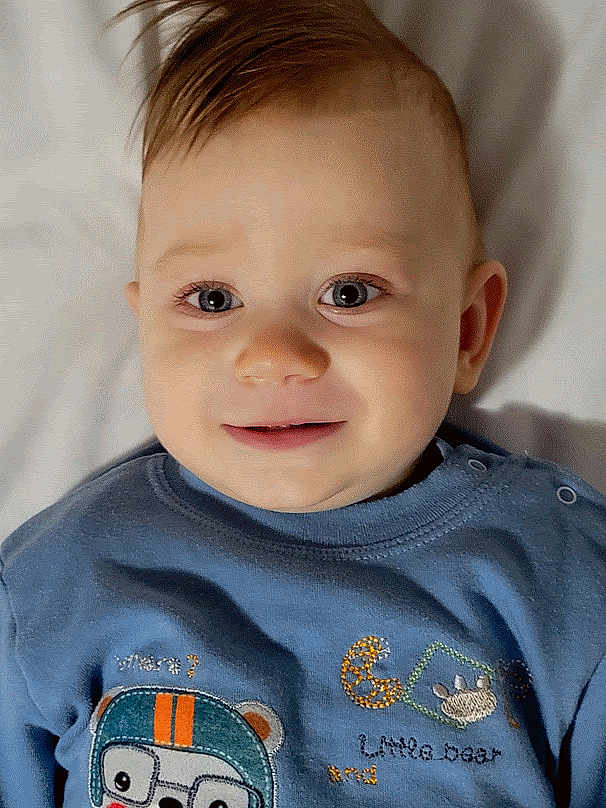 Liam joined the competition — help win amazing prizes! baby, infant, child, face, portrait, blue_shirt, cute, smile, eyes, hair, lying_down, soft_light, indoor, closeup, toddler, clothing, expression, skin, head, person