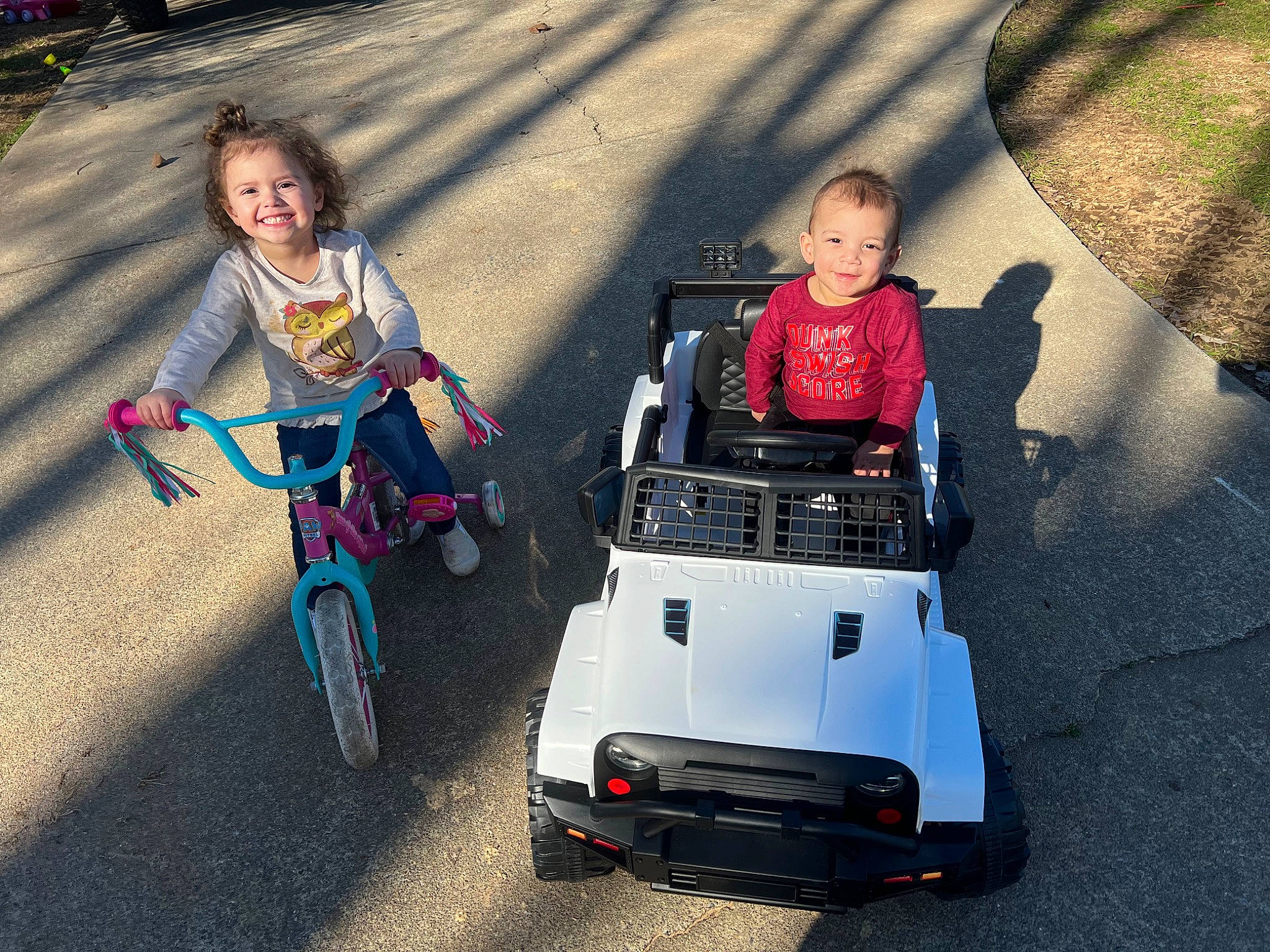 Adisyn is registered to the contest to win money with this photo: asphalt, automotive_design, automotive_exterior, automotive_tire, automotive_wheel_system, bicycles_equipment_and_supplies, bumper, fun, happy, joy, leisure, mode_of_transport, motor_vehicle, person, recreation, riding_toy, smile, snapshot, tire, toddler