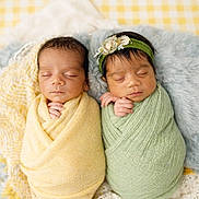 Leela joined the competition — help win amazing prizes! newborn, twins, baby, sleeping, wrapped, blanket, headband, flower, soft_texture, cushion, basket, yellow, green, cute, peaceful, portrait, indoors, infant, resting, cozy