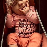 Octavia joined the competition — help win amazing prizes! baby, infant, sleeping, hat, knit, pink_clothing, onesie, cozy, cute, child, hand, mouth, face, newborn, soft_lighting, portrait, zipped_carrier, resting, small_hands, footwear