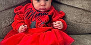 Ruth joined the competition — help win amazing prizes! baby, child, red_clothing, headband, bow, minnie_mouse, tights, sitting, sofa, couch, indoors, cute, infant, portrait, person, toddler, smiling, cozy, furniture, fashion