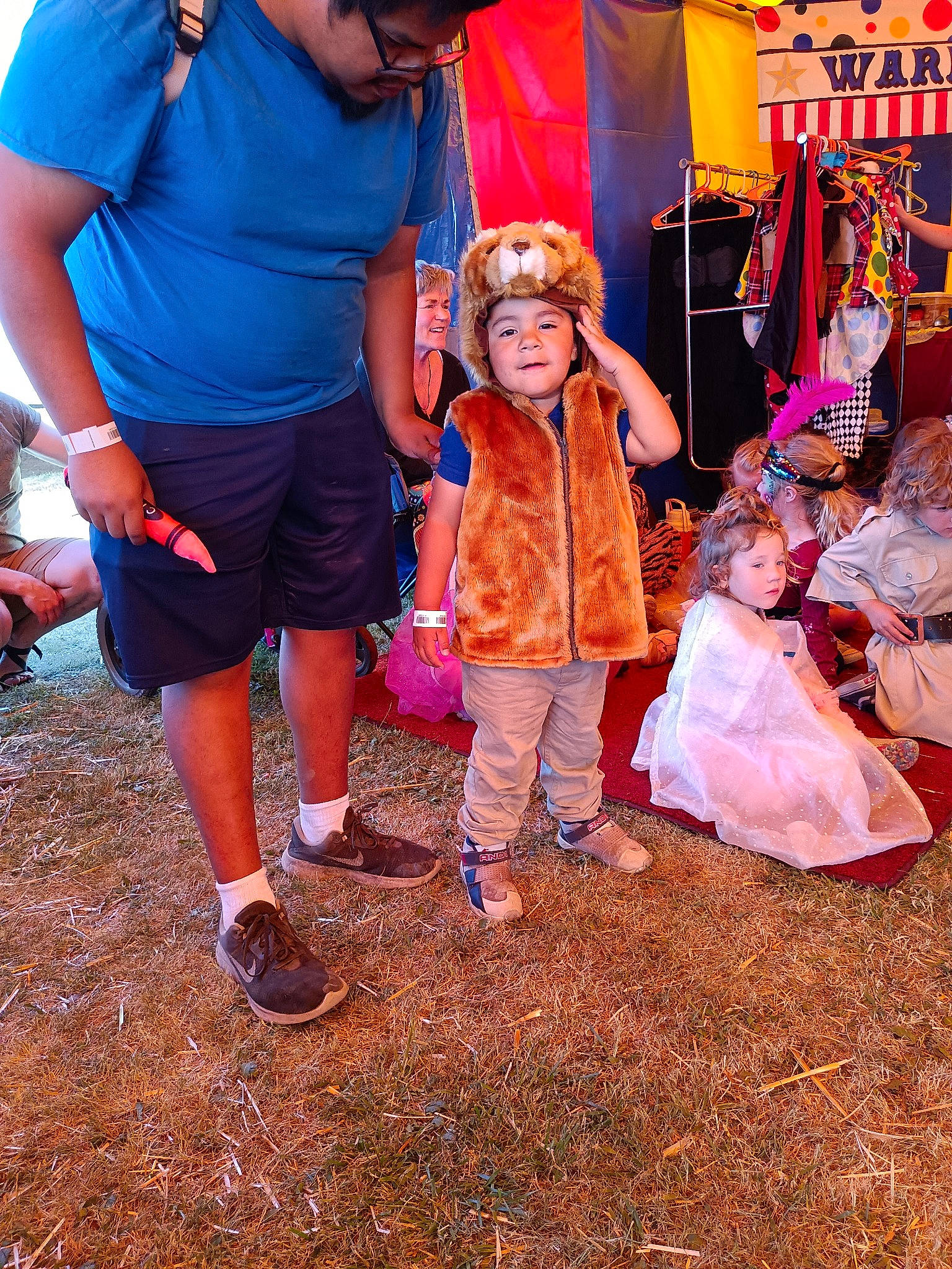 Matteo is registered to the contest to win money with this photo: child, costume, event, fun, grass, happy, hat, headwear, joy, leisure, magenta, orange, person, pink, plant, recreation, shorts, soil, sun_hat, t_shirt