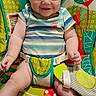 Noah joined the competition — help win amazing prizes! baby, smiling, child, onesie, striped_clothing, baby_seat, colorful, toy, soft_toy, happy, infant, cute, indoors, seatbelt, plush, person, portrait, sitting, wood_floor, young_child
