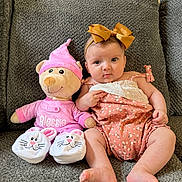 Blessie Rosalie joined the competition — help win amazing prizes! baby, teddy_bear, stuffed_animal, couch, gray_couch, bow, headband, pink_clothing, baby_clothes, indoor, plush_toy, child, smile, cute, seated, soft_toy, home, furniture, infant, portrait