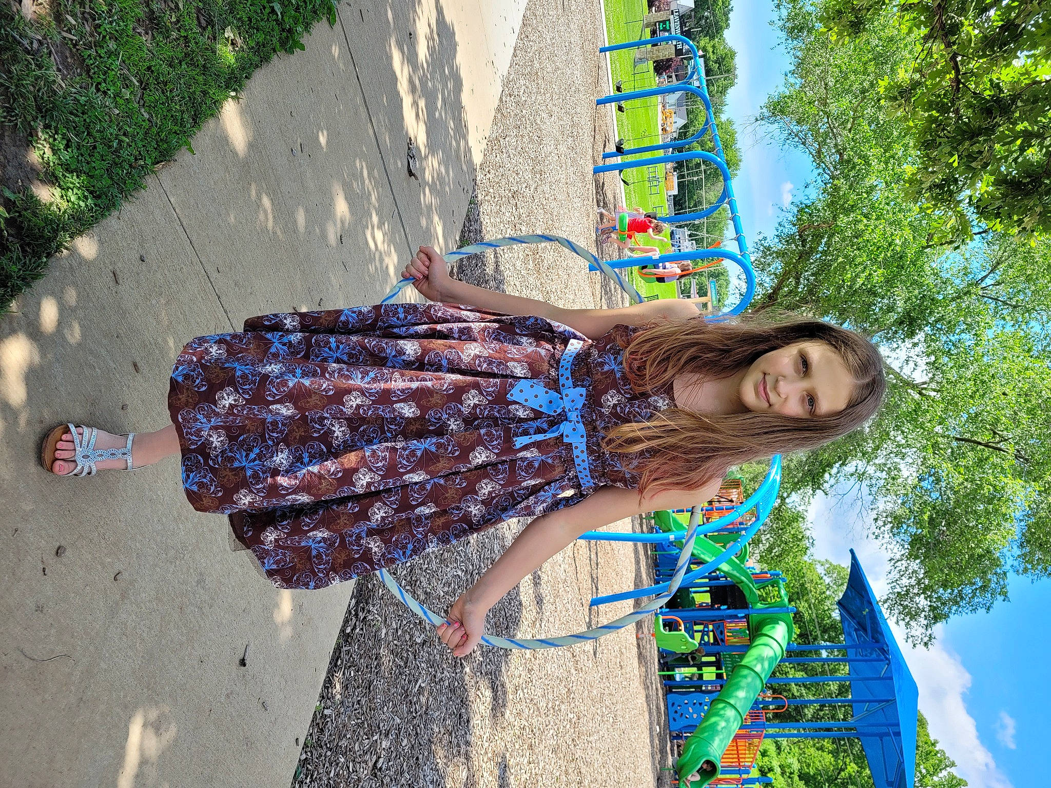 Skyla is registered to the contest to win money with this photo: asphalt, electric_blue, fun, grass, green, happy, human_leg, joy, leisure, pattern, people_in_nature, person, plant, recreation, road, road_surface, sidewalk, thigh, travel, tree