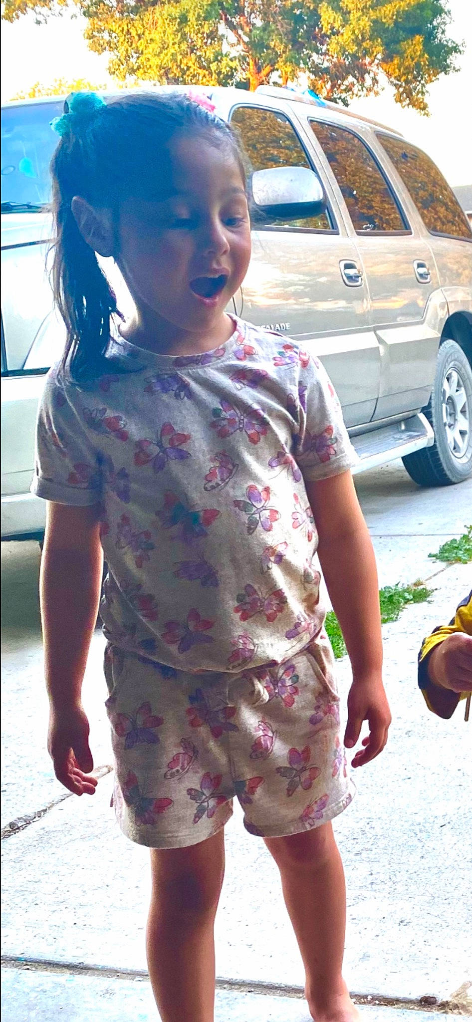 Epiphany is registered to the contest to win money with this photo: automotive_lighting, automotive_tire, car, face, facial_expression, hair, hairstyle, hand, motor_vehicle, person, photograph, plant, shoulder, skin, sleeve, smile, textile, tire, vehicle, wheel