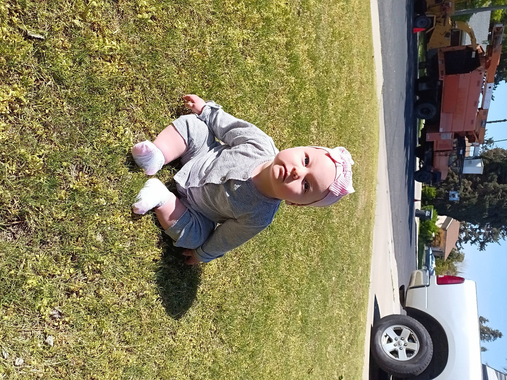 Fallon is registered to the contest to win money with this photo: automotive_exterior, automotive_tire, automotive_wheel_system, car, fun, grass, happy, headwear, lawn, leisure, motor_vehicle, people_in_nature, person, plant, recreation, rolling, tire, tree, vehicle, vehicle_door