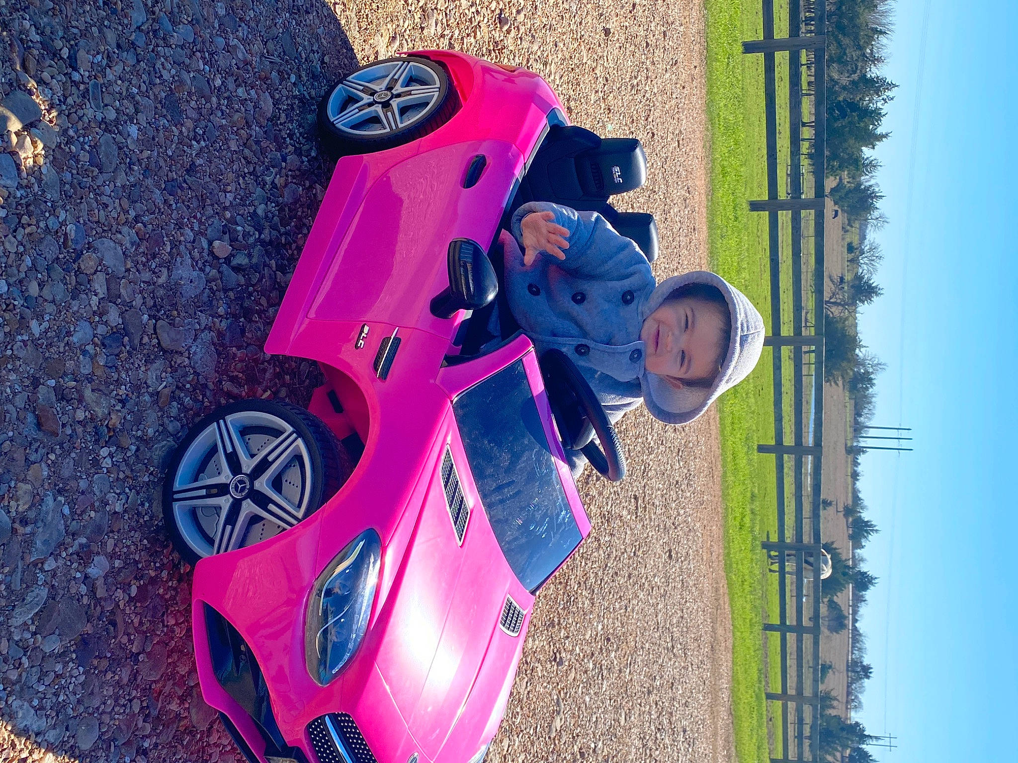 Raelynn is registered to the contest to win money with this photo: automotive_design, automotive_exterior, automotive_lighting, automotive_tire, blue, bumper, car, fender, hood, motor_vehicle, person, pink, purple, red, rim, sky, tire, vehicle, vehicle_door, wheel