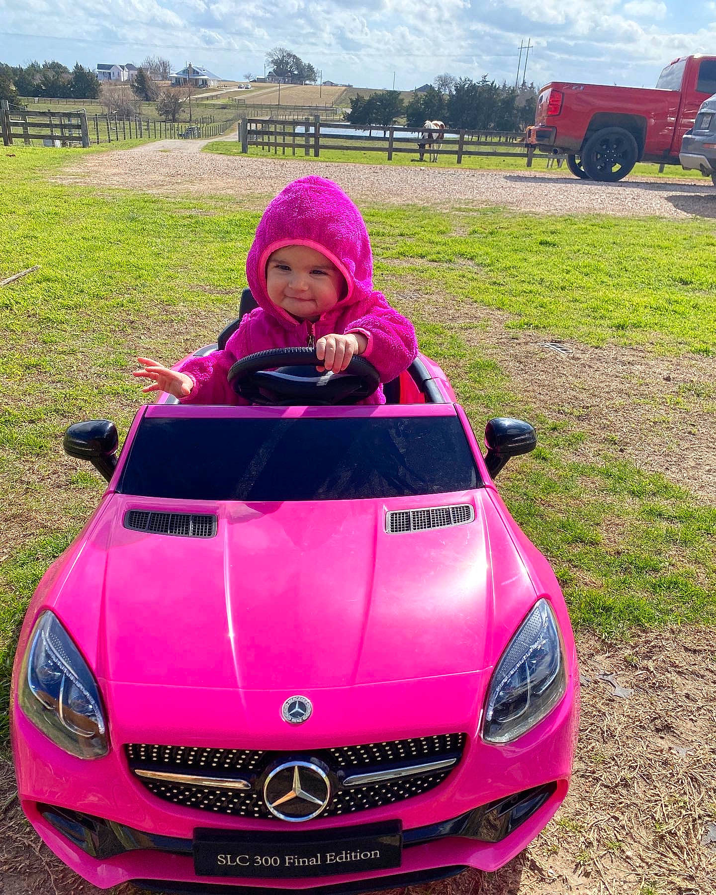 Raelynn joined the competition — help win amazing prizes! automotive_design, automotive_exterior, automotive_lighting, automotive_tire, bumper, car, cloud, grass, green, grille, headwear, hood, land_vehicle, motor_vehicle, natural_environment, person, pink, sky, tire, vehicle