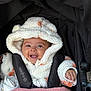 Alaiyah is registered to the contest to win money with this photo: baby, child, smiling, hooded_jacket, stroller, blanket, happy, face, person, cute, warm_clothing, infant, seated, outdoor, hand, pink_blanket, white_jacket, orange_spots, cozy, portrait