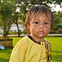 Manoa participe au concours pour gagner de l'argent avec cette photo : toddler, child, portrait, outdoor, grass, yellow_shirt, curious, face, expression, nature, daylight, young_child, person, park, serious, brown_eyes, messy_face, casual_clothing, short_hair, sunlight