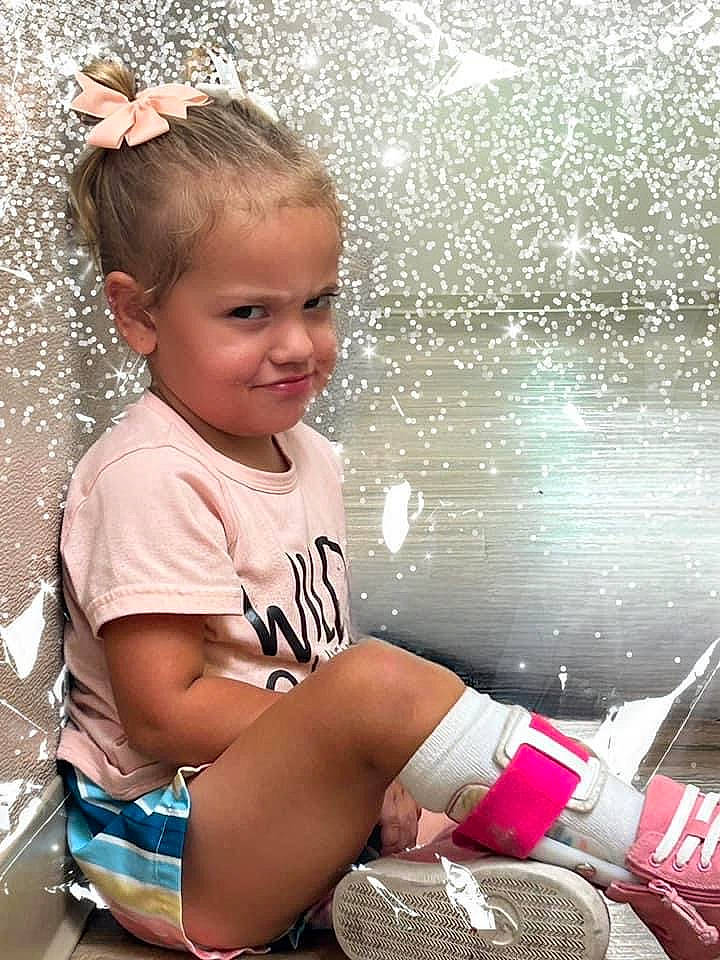 River is registered to the contest to win money with this photo: ball, beauty, child, cool, facial_expression, flash_photography, fun, happy, human_leg, joy, leisure, person, shorts, sitting, smile, snapshot, t_shirt, thigh, toddler, vacation