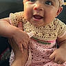 baby, child, smiling, headband, crocheted_dress, cute, infant, hand, car_interior, seat, person, happy, portrait, young_child, clothing, sitting, skin, face, cute_expression, toddler