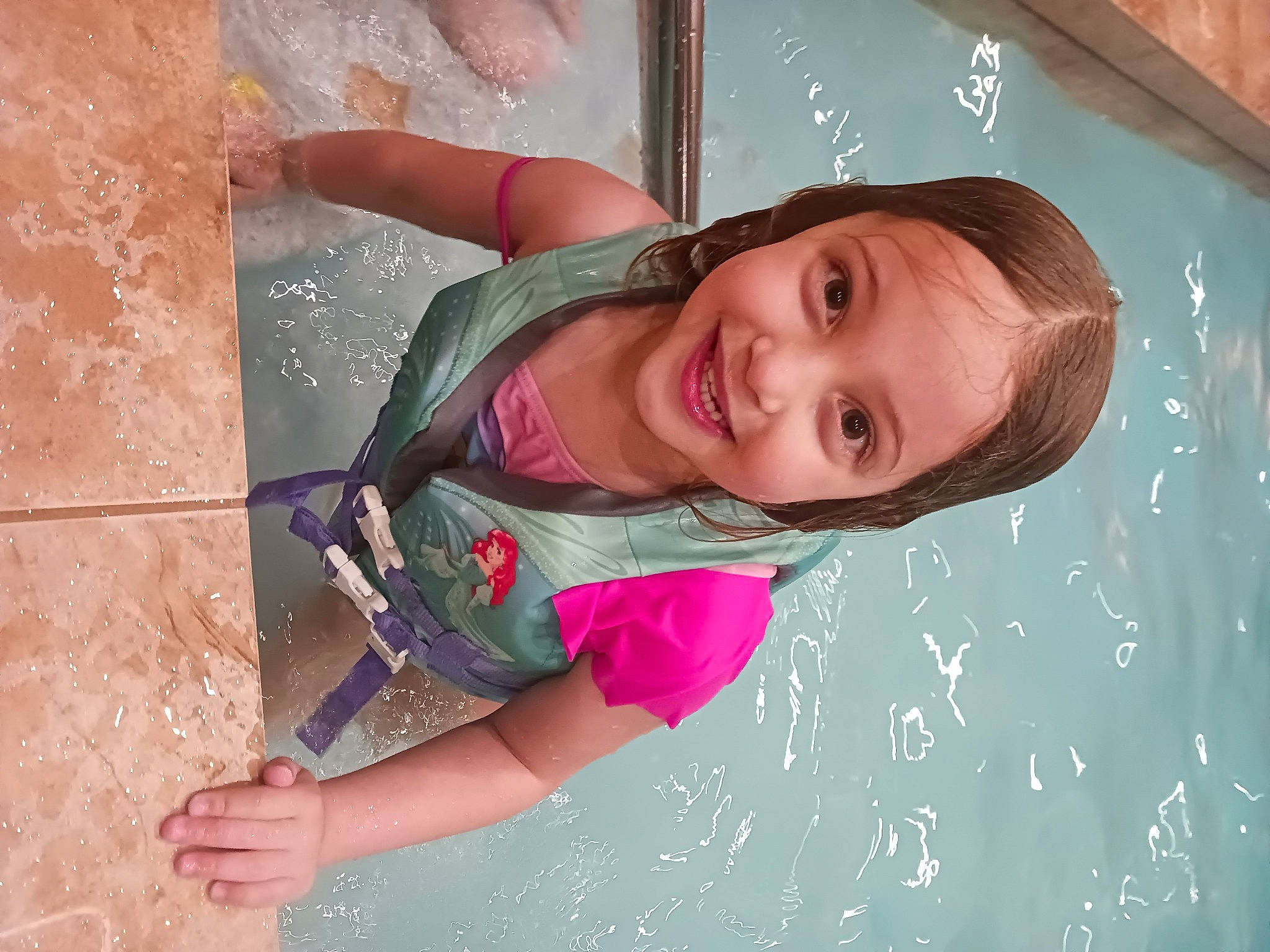 Lila is registered to the contest to win money with this photo: azure, child, facial_expression, fun, hand, happy, human, joy, leisure, magenta, outdoor_play_equipment, people_in_nature, person, pink, play, skin, smile, toddler, tree, water