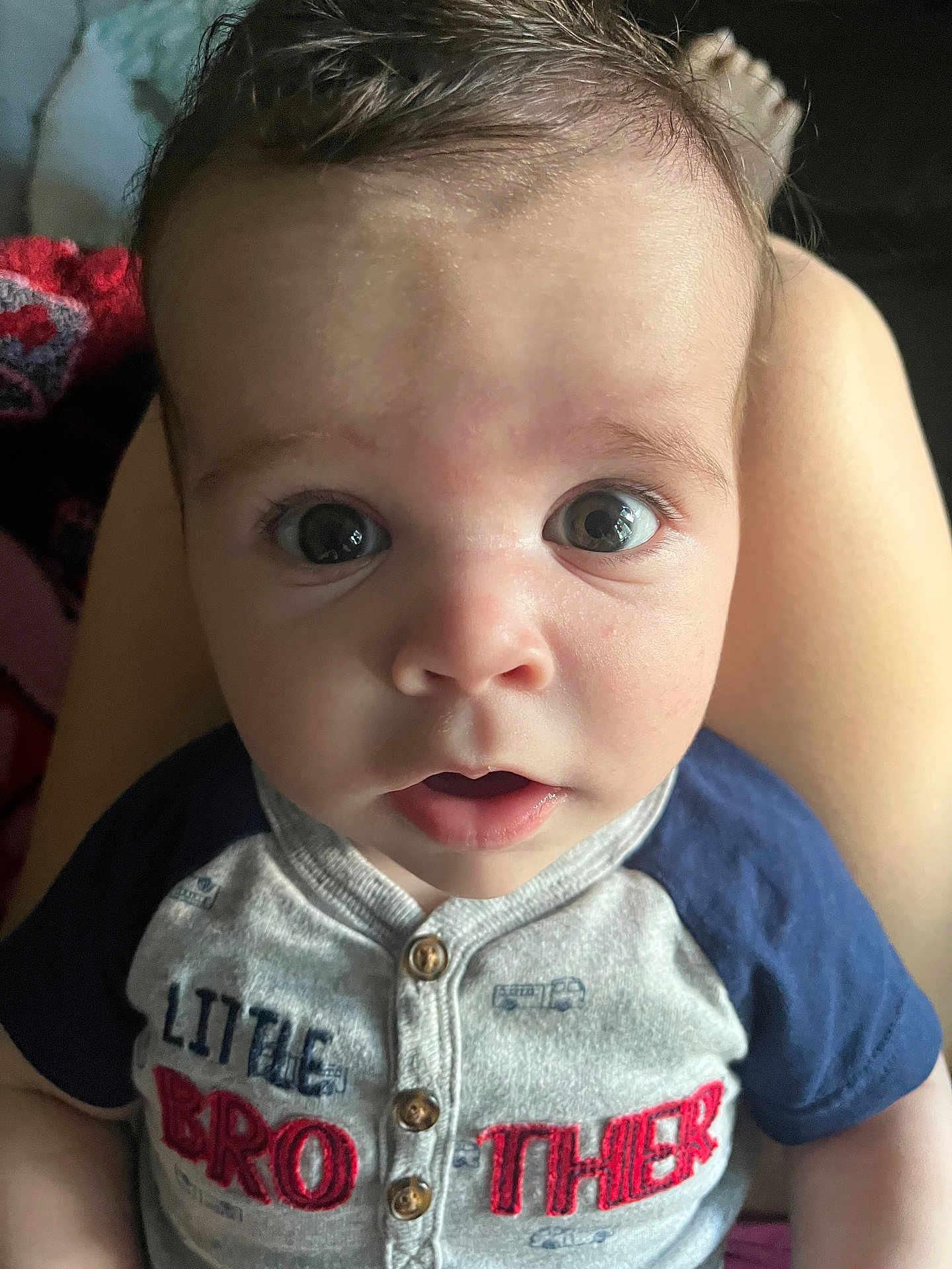 Cameron is registered to the contest to win money with this photo: baby, child, infant, face, eyes, expression, curious, shirt, clothing, sitting, legs, person, portrait, indoors, closeup, cute, young, skin, head, mouth