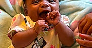 Serenity is registered to the contest to win money with this photo: baby, infant, smile, happy, clothing, headband, blanket, hand, cute, child, mickey_mouse, pattern, lying_down, indoors, skin, person, apparel, toddler, joy, playful