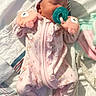 baby, sleeping, pacifier, pink_clothing, mittens, bow_hat, blanket, soft_light, infant, cute, cozy, floral_pattern, newborn, resting, indoors, child, person, closeup, toddler, portrait