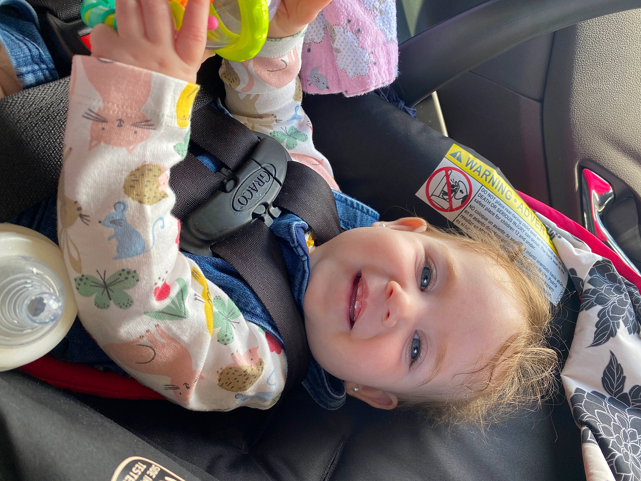 Isabell is registered to the contest to win money with this photo: auto_part, automotive_design, car, car_seat, car_seat_cover, child, comfort, face, family_car, happy, head_restraint, motor_vehicle, nail, person, smile, steering_wheel, toddler, travel, vehicle_door, vertebrate