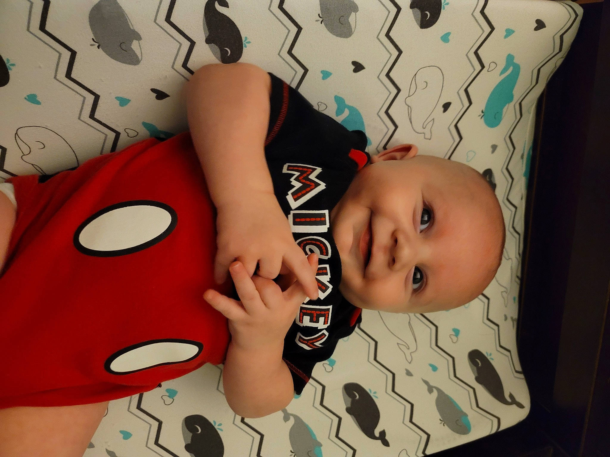 Desmond is registered to the contest to win money with this photo: baby, baby_toddler_clothing, child, comfort, cool, eyelash, facial_expression, finger, font, gesture, happy, joy, mouth, nail, pattern, person, sleeve, t_shirt, textile, thumb