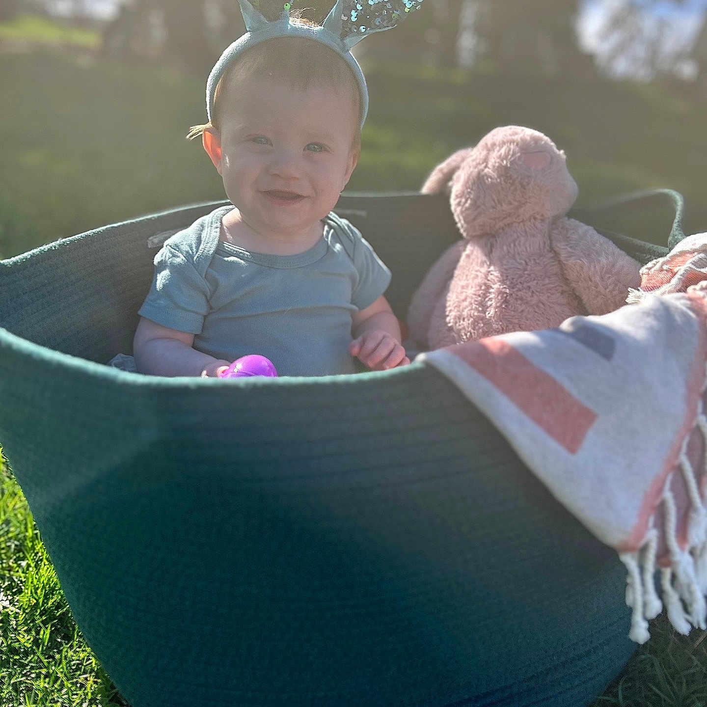 Liam is registered to the contest to win money with this photo: baby, basket, face, furniture, grass, happy, head, medication, nature, outdoors, park, person, photography, pill, plant, playarea, portrait, pottedplant, summer, toy