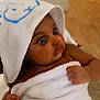 Keyssie Kaely participe au concours pour gagner de l'argent avec cette photo : baby, towel, hood, wrapped, curious, indoor, skin, hand, infant, child, cute, soft, expression, portrait, young, newborn, brown_skin, person, sitting, warm