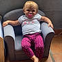 toddler, child, pacifier, purple_leggings, white_tshirt, armchair, indoor, tile_floor, relaxed, smiling, blond_hair, furniture, person, casual, seated, small_chair, cute, baby, home, portrait