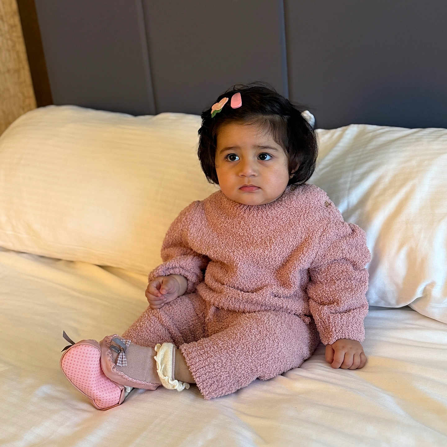 Aayat joined the competition — help win amazing prizes! baby, bed, candid, child, comfortable, cozy_clothing, cute, expression, hair_clip, indoors, neutral_background, person, pink_outfit, pink_shoes, portrait, sitting, soft_lighting, toddler, white_bedspread, young_child