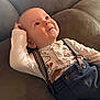 Thïlyo participe au concours pour gagner de l'argent avec cette photo : baby, child, clothing, couch, curious, cute, expression, face, human, indoor, infant, patterned_shirt, person, portrait, relaxing, seated, smiling, soft_lighting, suspenders, young