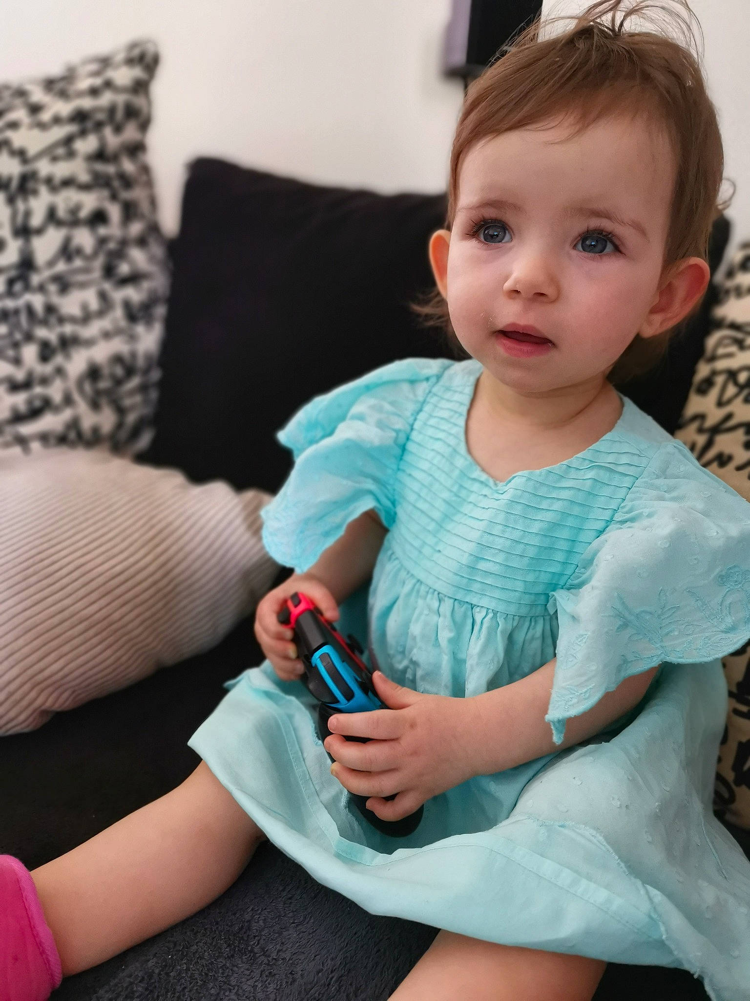 Margaux participe au concours pour gagner de l'argent avec cette photo : baby_toddler_clothing, cheek, comfort, couch, dress, eyelash, face, happy, head, iris, joint, knee, lip, neck, person, shoulder, skin, sleeve, textile, thigh
