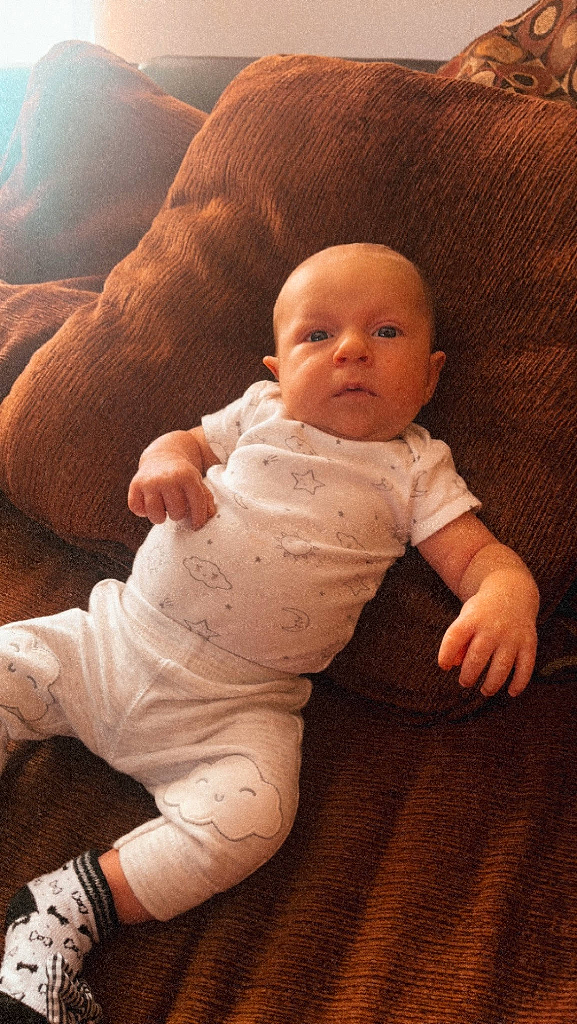 Destin is registered to the contest to win money with this photo: baby, baby_toddler_clothing, cheek, comfort, eye, finger, flooring, gesture, hand, human_body, iris, leg, lip, mouth, nose, person, skin, sleeve, stomach, thumb