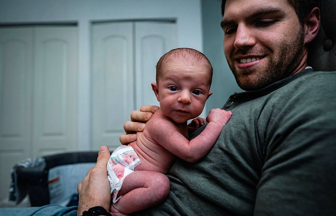 Destin is registered to the contest to win money with this photo: baby, beard, cheek, child, comfort, door, elbow, event, flash_photography, fun, gesture, happy, headwear, joint, joy, muscle, person, sitting, skin, smile