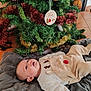 baby, infant, christmas_tree, ornament, holiday, decoration, blanket, floor, indoors, festive, cute, reindeer_outfit, toddler, child, smiling, christmas, celebration, warm_clothing, toy, home