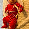adorable, angel_wings, baby, blanket, bow_and_arrow, child, costume, cute, heart_shape, holiday_costume, indoors, infant, infant_baby, love, lying_down, playful, portrait, prop, red_clothing, soft_texture