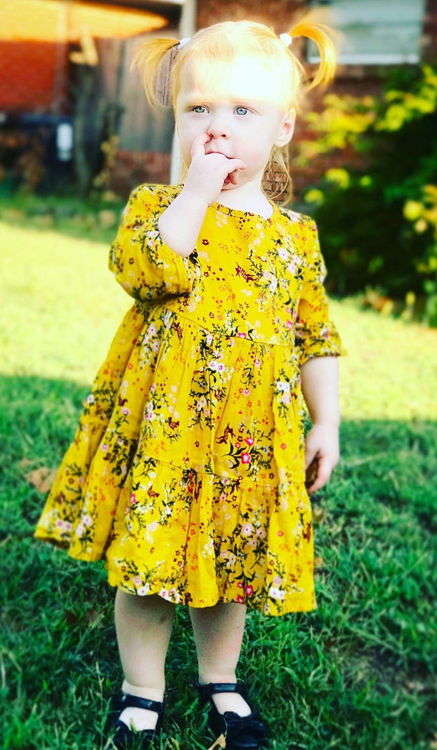 Harper joined the competition — help win amazing prizes! blond, child, child_model, clothing, day_dress, design, dress, flower, grass, joint, outerwear, pattern, person, plant, sleeve, spring, summer, textile, toddler, yellow