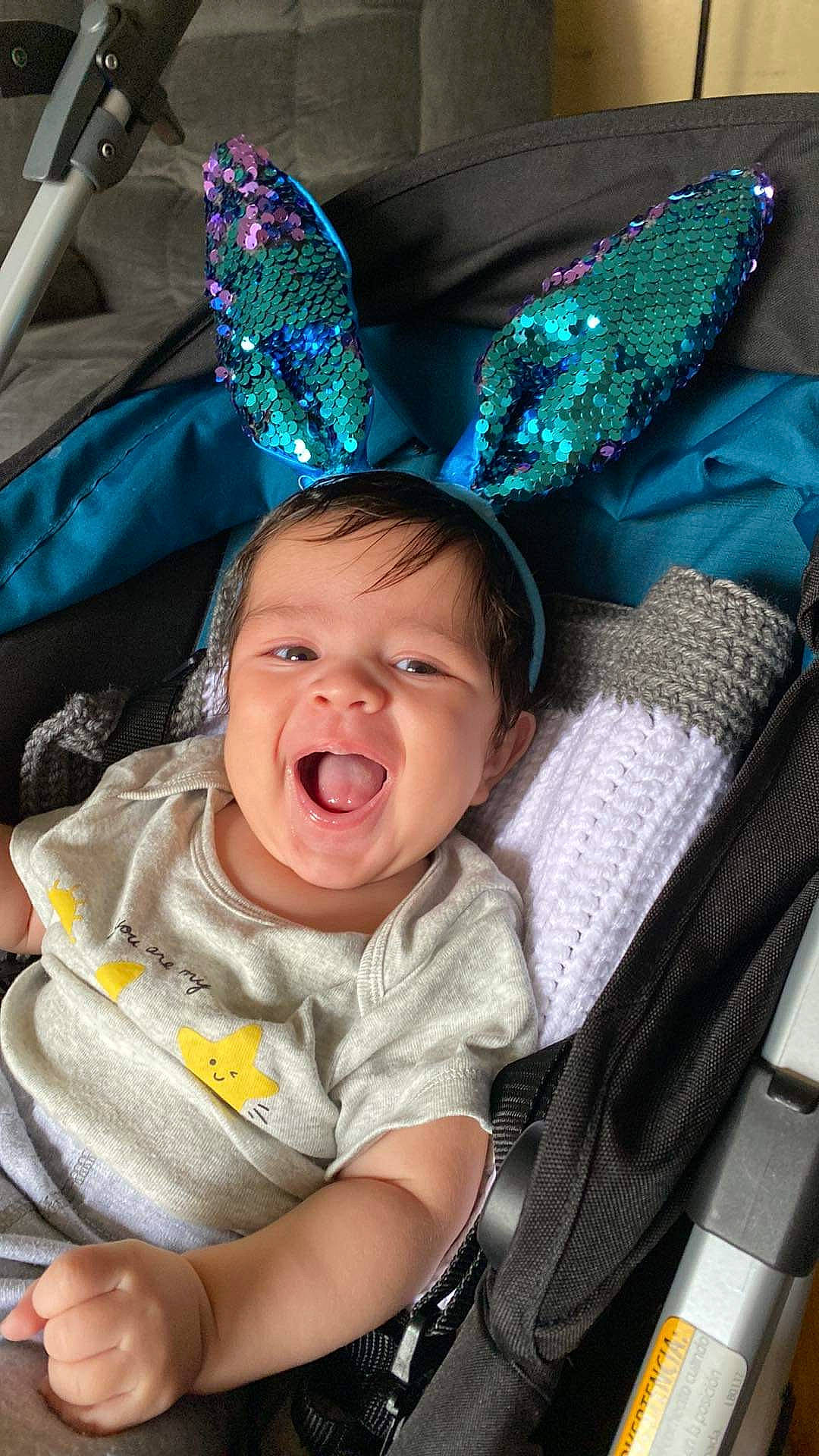 Isaac joined the competition — help win amazing prizes! baby, baby_carriage, baby_products, baby_toddler_clothing, black, blue, cheek, child, comfort, costume_hat, fashion_accessory, fun, green, happy, headgear, party_hat, person, sitting, smile, toddler