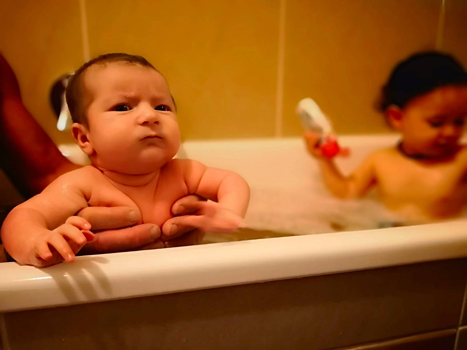 Lidia is registered to the contest to win money with this photo: baby, baby_bathing, bathing, bathtub, birth, cheek, child, face, fun, hand, person, plumbing_fixture, product, skin, toddler