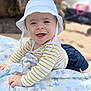 Marius participe au concours pour gagner de l'argent avec cette photo : baby, child, hat, bucket_hat, striped_shirt, long_sleeve, blanket, star_pattern, beach, sand, smiling, happy, blue_eyes, infant, toddler, clothing, outdoor, person, stroller, blurred_background