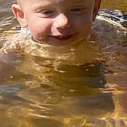 Jamison joined the competition — help win amazing prizes! child, toddler, water, outdoor, blond_hair, wet_hair, smile, face, sunlight, reflection, nature, play, summer, happy, head, person, water_surface, ripples, skin, closeup